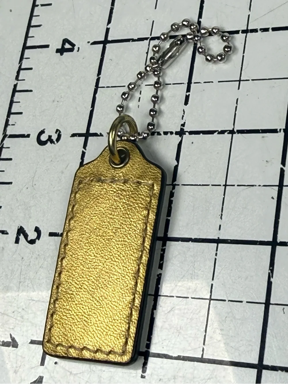 Coach two tone embossed gold front & metallic Leather back hang tag Key w Chain